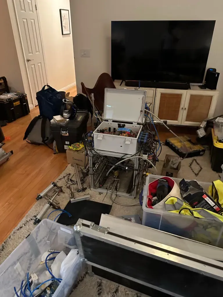 Rocket ground support equipment and tools spread across a living room
